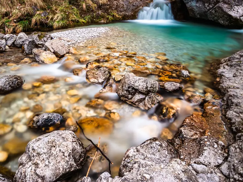 Crystal-clear mountain stream flowing over rocks
